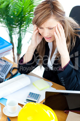 Stressed businesswoman having a headache