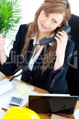 Portrait of a busy businesswoman talking on phone