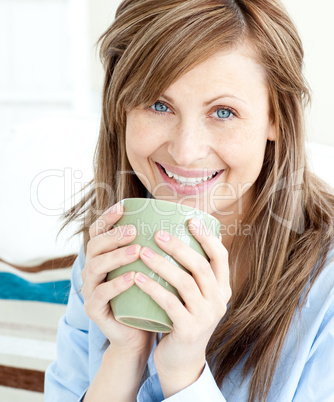 Positive attractive businesswoman holding a cup