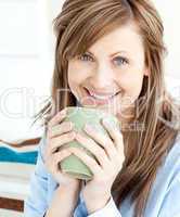 Positive attractive businesswoman holding a cup