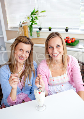 Handsome friends eating ice and smiling at the camera