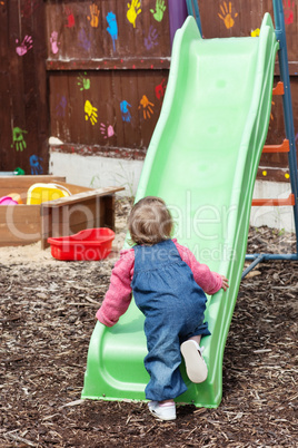 Little girl having fun with a chute