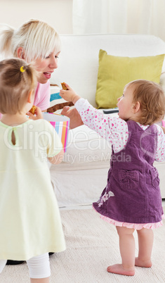 Smiling having fun with her girls in the living-room