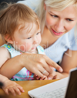 happy woman surfing on the internet with her girl in the living-