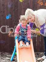 Smiling girl and her mother having fun with a chute