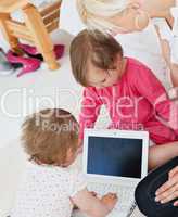 Radiant family having fun with a laptop in the living-room