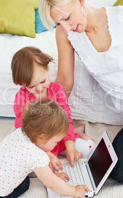 Cute family having fun with a laptop in the living-room