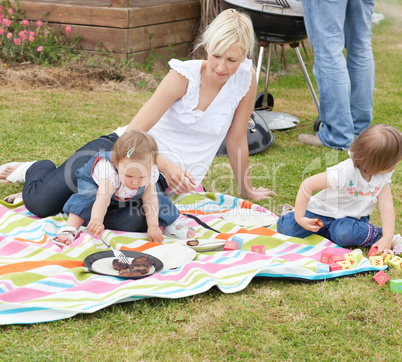 Mother and daughters having a picnic together