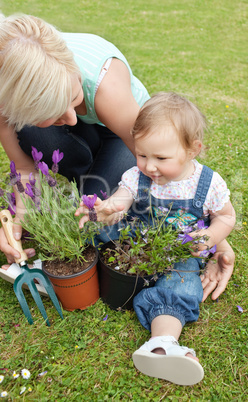 Beautiful mother showing her daughter a purple flower