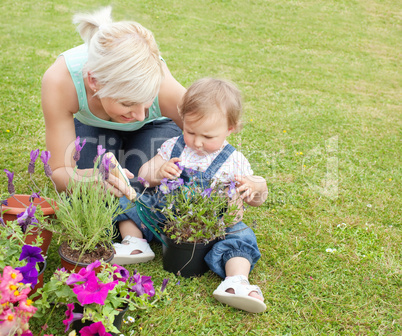 Mother showing her daughter a purple flower