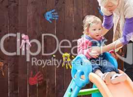 Little girl and her mother having fun with a chute