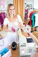 Caucasian woman is paying items