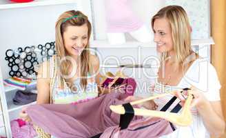 Two cheerful women choosing clothes together