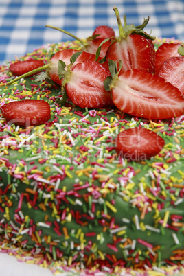 Delicious strawberry cake on table