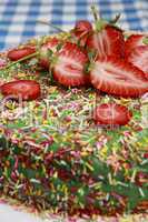 Delicious strawberry cake on table