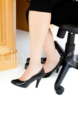 Woman sitting on a chair with her feet on the floor