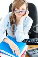 Smilling female doctor with glasses sitting in office