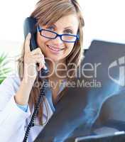 Beautiful female doctor with glasses sitting in office
