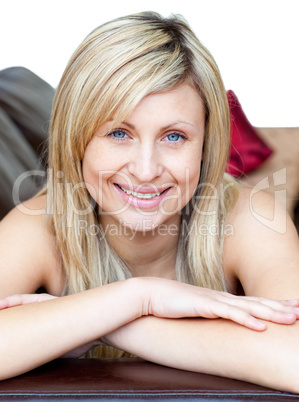 Cute woman lies on a brown sofa