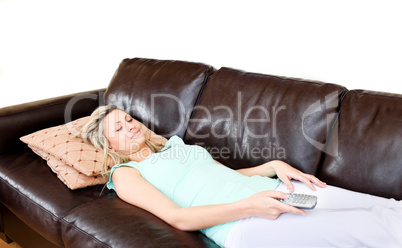 Laid-back woman lies on sofa and watches TV