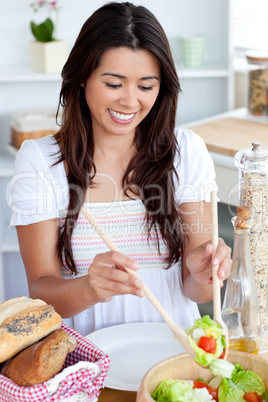 Young female woman preparing salad in kitchen