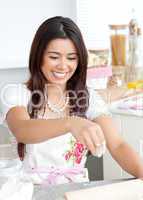 Bright female woman is cooking in kitchen
