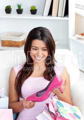 Beautiful woman holding shoe in her hand