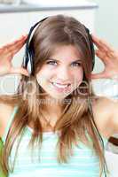 Positive woman listening to music with headphones