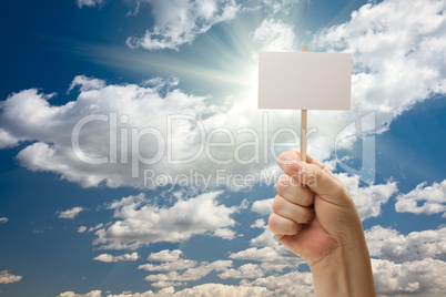 Man Holding Blank Sign Over Clouds and Sky