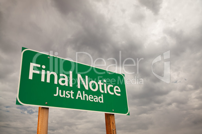 Final Notice Green Road Sign Over Storm Clouds