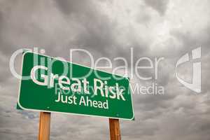 Great Risk Green Road Sign Over Storm Clouds