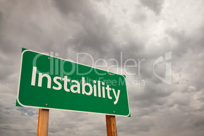Instability Green Road Sign Over Storm Clouds