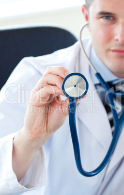 Male doctor holding a stethoscope