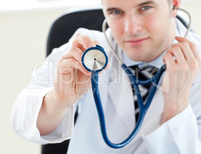 Portrait of a charming male doctor holding a stethoscope