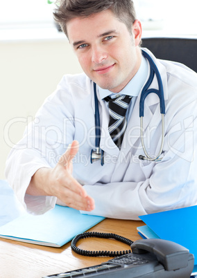 Smiling doctor holding out his hand