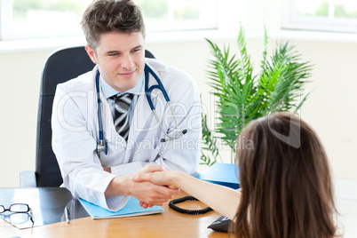 Delighted male doctor welcome his patient