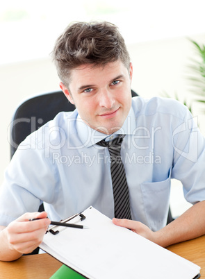 Smiling businessman showing a contract to a customer