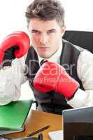 Angry businessman wearing boxing gloves