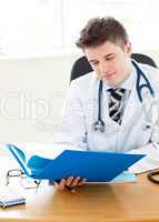 Handsome young doctor holding a folder
