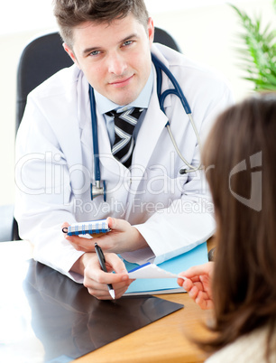 Young male doctor giving prescription to a patient