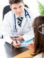 Young male doctor giving prescription to a patient