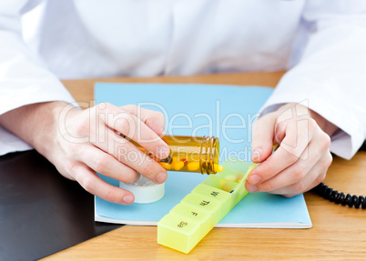 Close-up of a doctor giving pills to a patient
