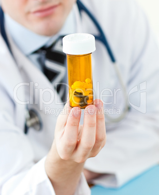 Young doctor holding pills