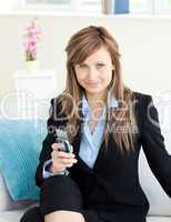 Serious attractive businesswoman using her mobile phone