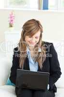 Charming businesswoman using her laptop