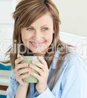 Beautiful woman holding a cup looking to the side