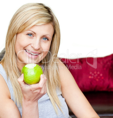 Joyful woman eating an apple