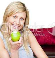 Joyful woman eating an apple