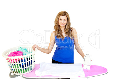Unhappy woman with clothes behind ironing board