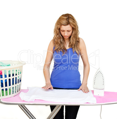 Concentrated woman behind an ironing board